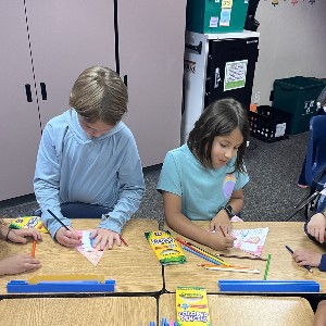 4th grade students making a craft with 1st grade students